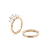 Emerald Cut with Emerald Side Stones Yellow Gold with Wedding Band